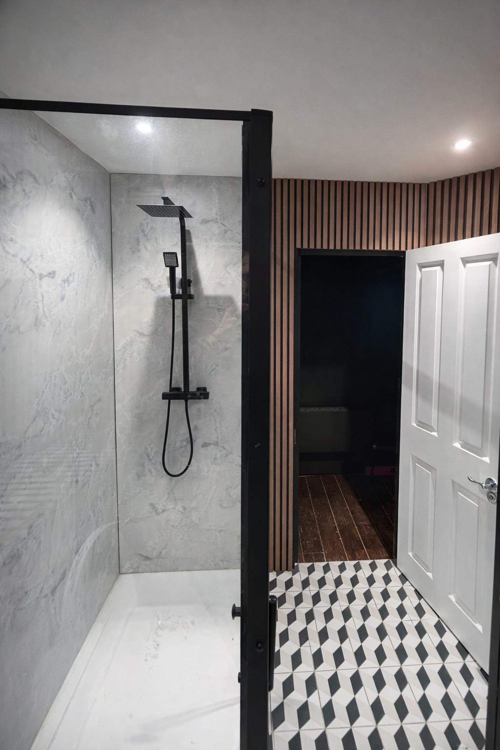 Walk-in shower with marble tiles, black rain shower head and wood slat panelling